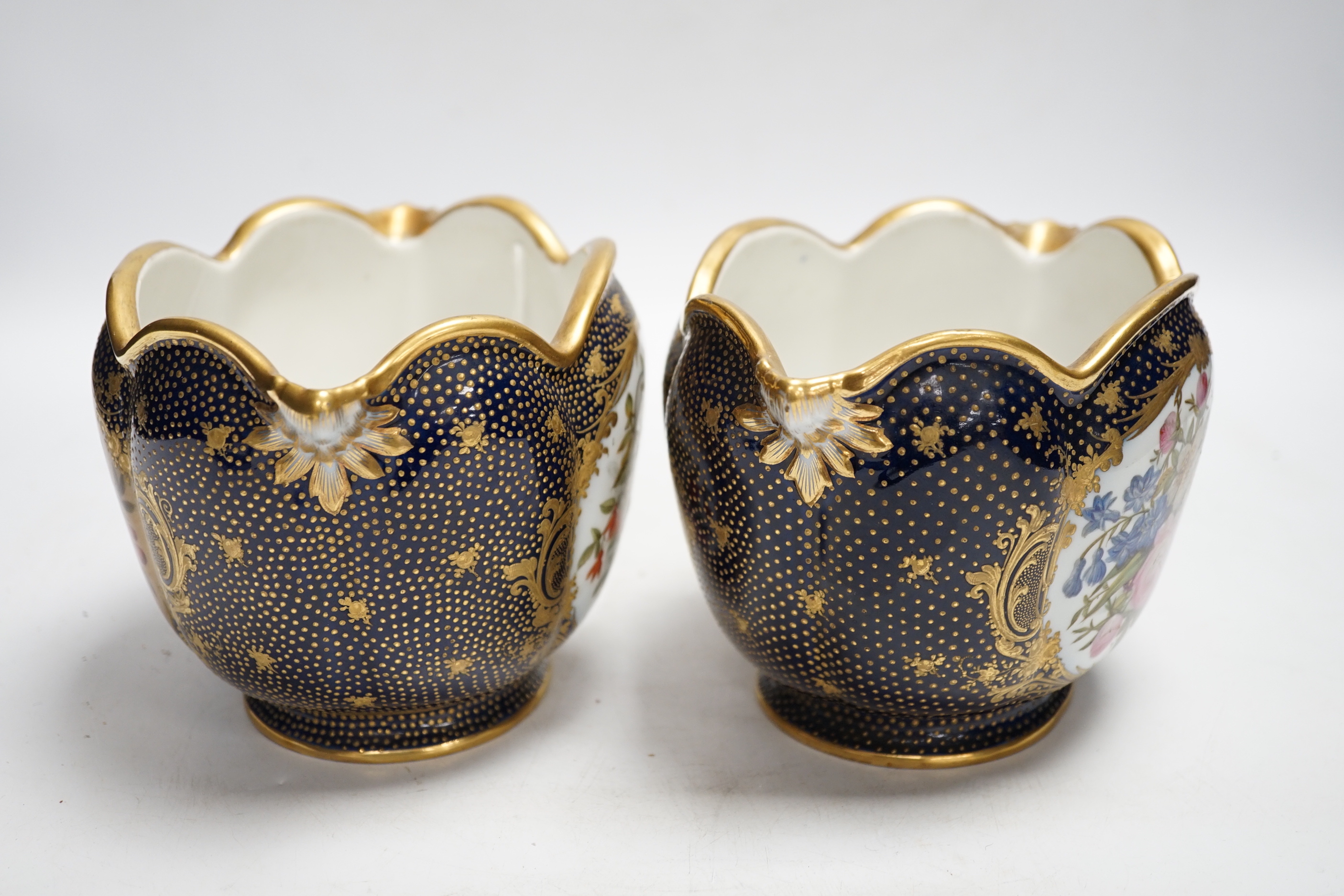 A pair of 19th century Paris porcelain cache pot hand painted with flowers and gilded decoration, 12cm high